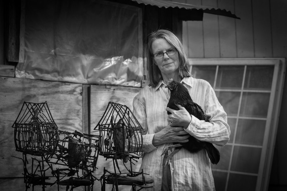 Portrait photography in Richmond, VA, of a woman with a chicken.